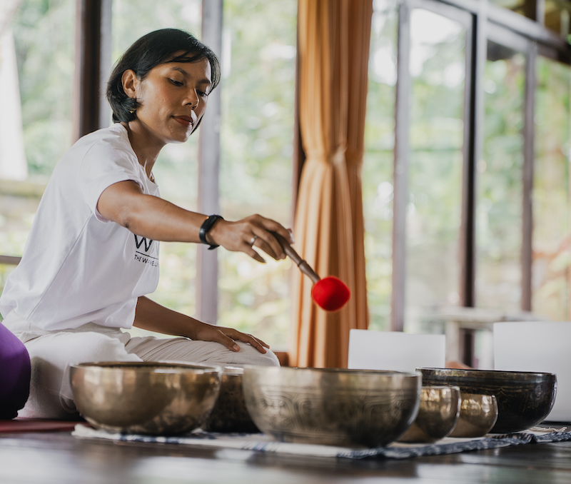 Yanti Panjaitan playing Tibetan singing bowls in the shala