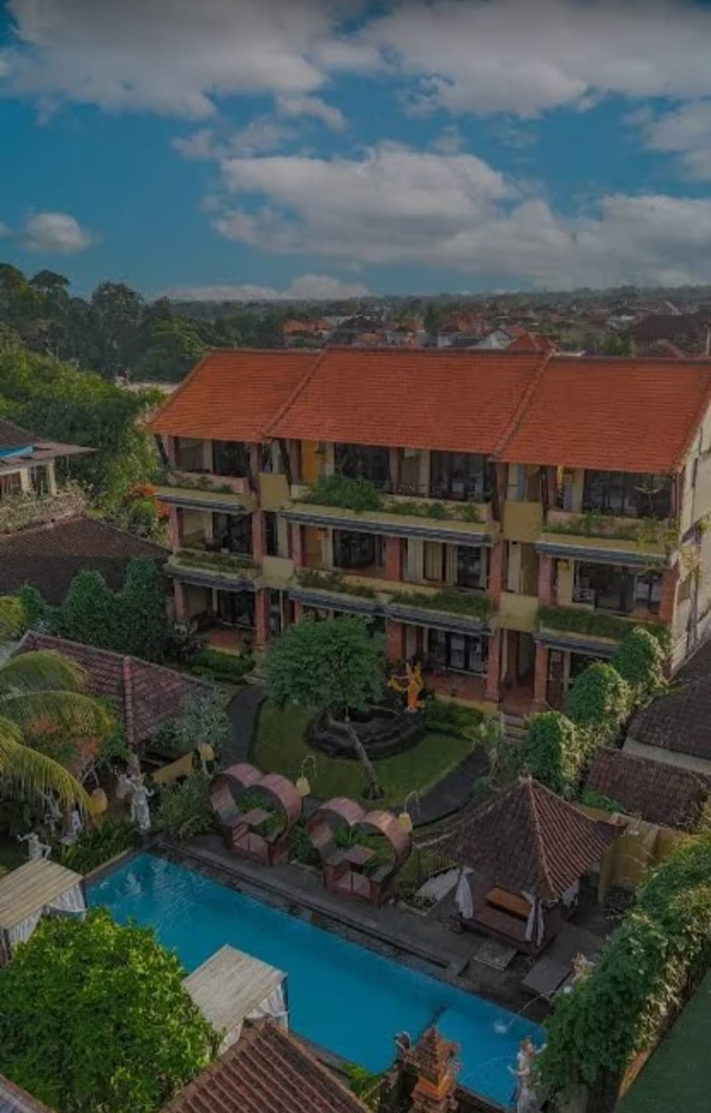 Aerial view of Pondok Kutuh Guest House showing the courtyard, pool and traditional roofs