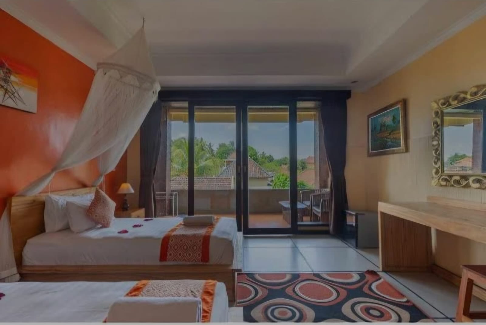 A twin room with a private balcony overlooking Ubud rooftops