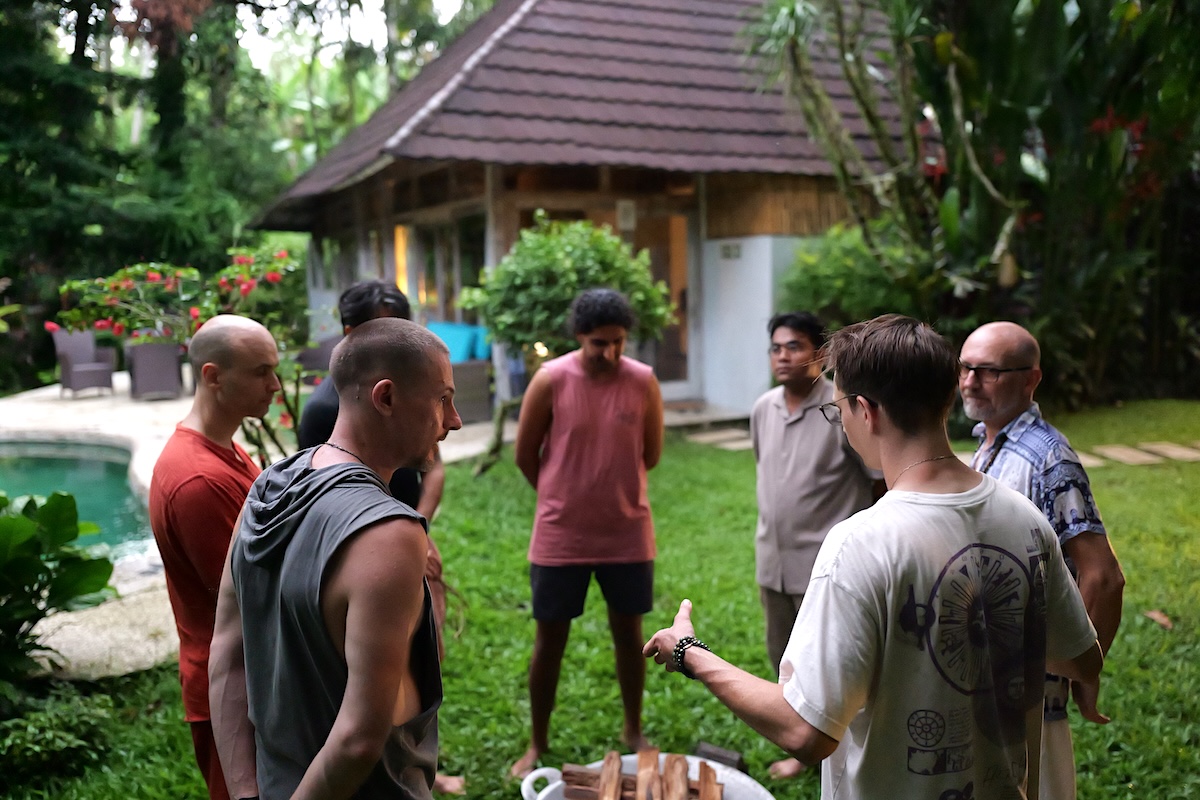 Men gathered by the poolside preparing the fire offering