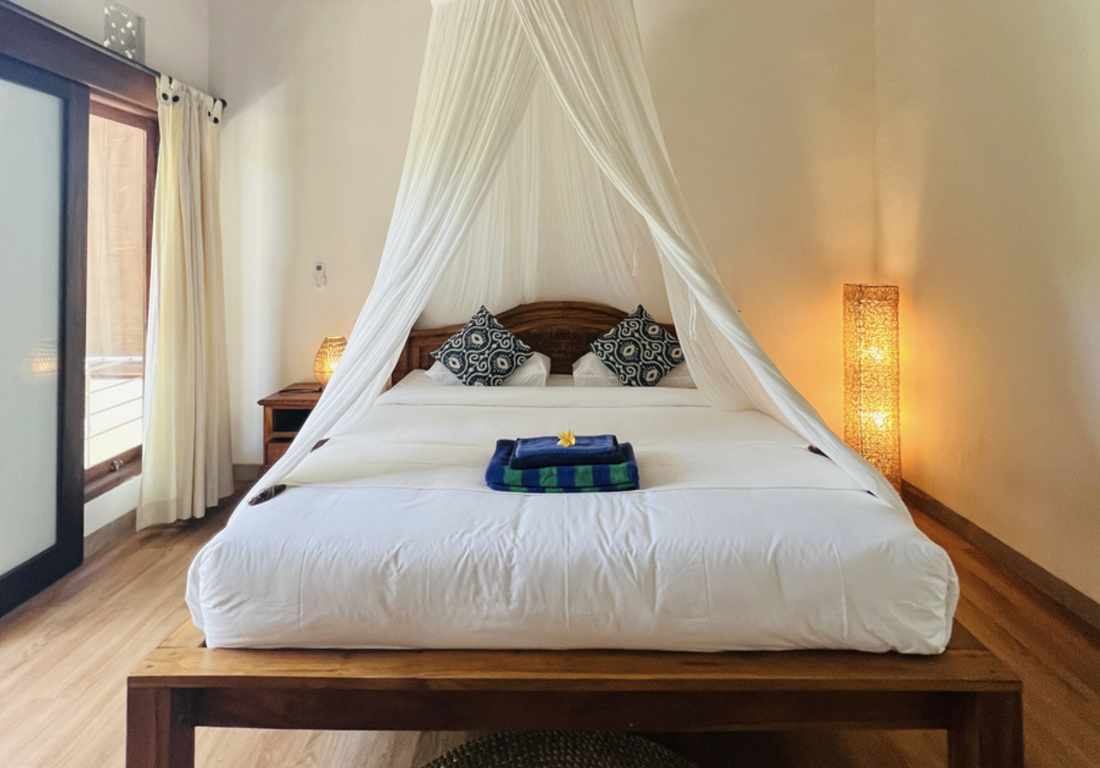 Cottage bedroom with canopy bed and soft evening light